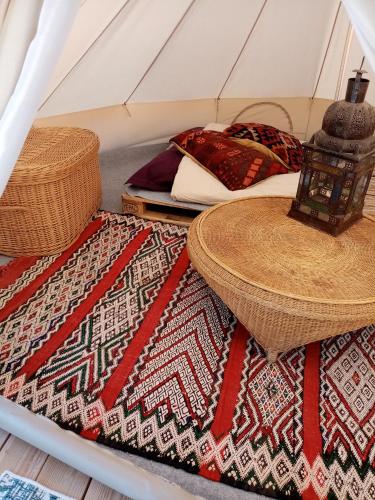 a room with two beds and two rugs in a tent at Ecolodge de la Ferme du Chant de Cailloux in Die