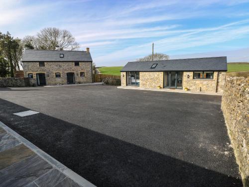 an empty parking lot in front of a stone building at The Cwtch in Bridgend