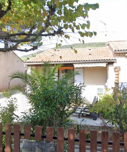 a house with a fence in front of it at Au coeur de la Provence Verte in Le Cannet-des-Maures