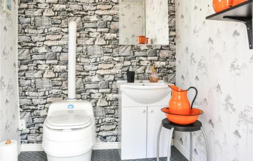 La salle de bains est pourvue de toilettes blanches et d'un mur en pierre. dans l'établissement Stunning Home In Kristinehamn With Wifi, à Edet