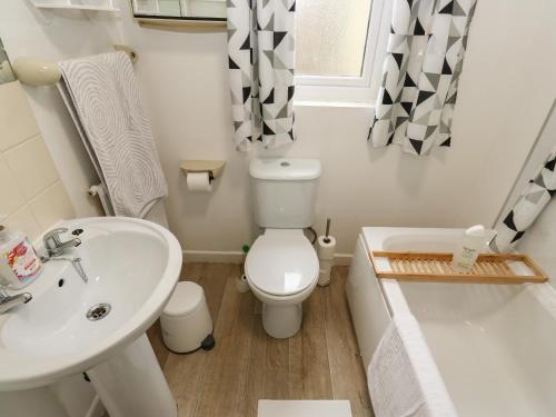 a small bathroom with a toilet and a sink at Avaelie Too in Hebden Bridge