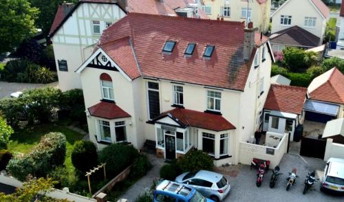 an aerial view of a large white house with cars parked at Cleave Court Guest House in Llandudno
