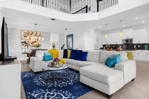 a living room with a couch and a table at Stylish Resort Villa w Pool Near Disney Gated 5BR in Kissimmee