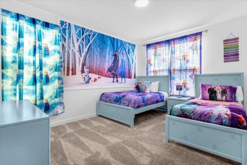 a bedroom with two beds and a painting on the wall at Stylish Resort Villa w Pool Near Disney Gated 5BR in Kissimmee