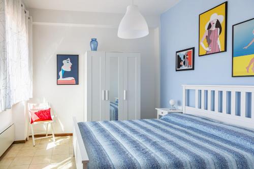 a blue bedroom with a bed and a chair at Graziella House in Brenzone sul Garda