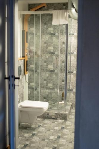 a bathroom with a toilet and a glass shower at RedCity LOFT 116 in Żyrardów
