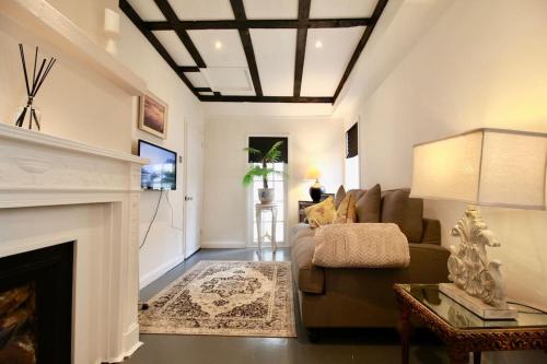 a living room with a couch and a fireplace at The Little Cottage By Air Premier in Seaford