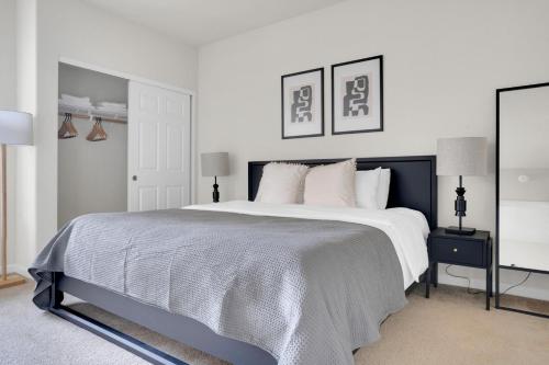 a white bedroom with a large bed and two lamps at San Bruno 1BR w Pool Gym WD nr highways SFO-995 in San Bruno