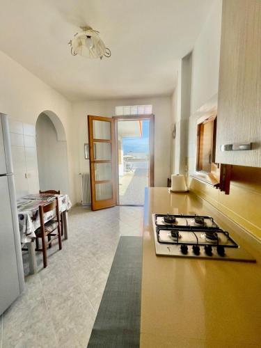 a kitchen with a stove top oven in a room at Crisimò vacanze in Tiggiano