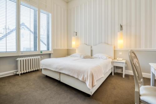 Ένα ή περισσότερα κρεβάτια σε δωμάτιο στο Hotel Made In Louise