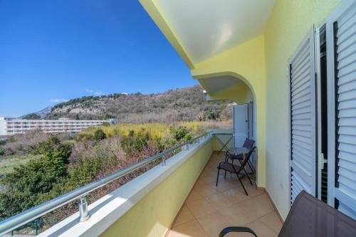 a balcony with chairs and a view of a mountain at Apartmani Milacic in Sutomore