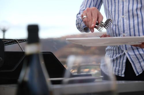 a man holding a plate of food with a fork at Country House Elite in Cascia