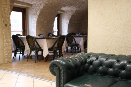 a couch in a room with a table and chairs at Country House Elite in Cascia