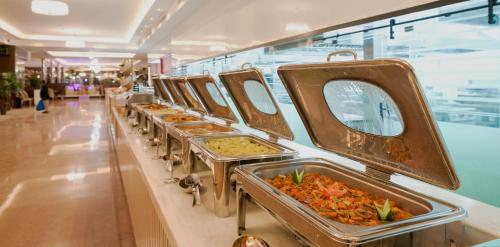 a row of trays of food on display in a store at فندق سنبات بلاتينيوم in Jazan