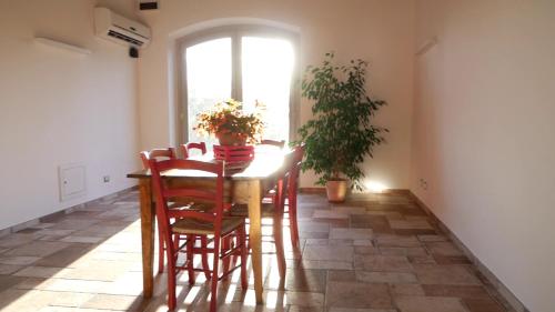 a dining room with a table and chairs and a window at Agriturismo I Due Casali in Vetralla