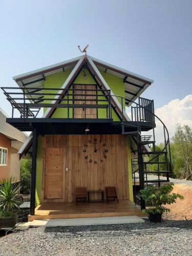 a house with a balcony on top of it at หวานใจ โฮมสเตย์ (Whanjai Homestay) in Trat