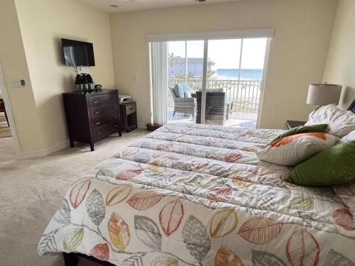 een slaapkamer met 2 bedden en een balkon met uitzicht op de oceaan bij A Touch of Modern with Views Condo in Manasota Key