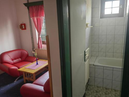 a bathroom with two red chairs and a bath tub at Zlatiborski Kutak in Zlatibor
