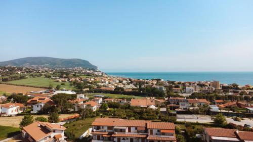 a small town with houses and the ocean at Pietra Bianca Residence in Numana