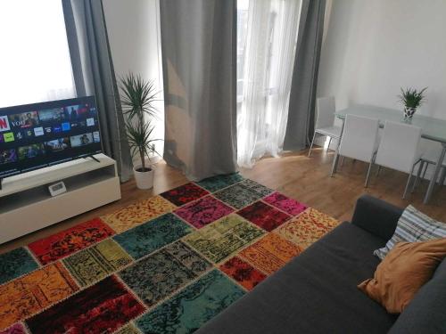a living room with a colorful rug on the floor at White City Apartment, your London stay in London