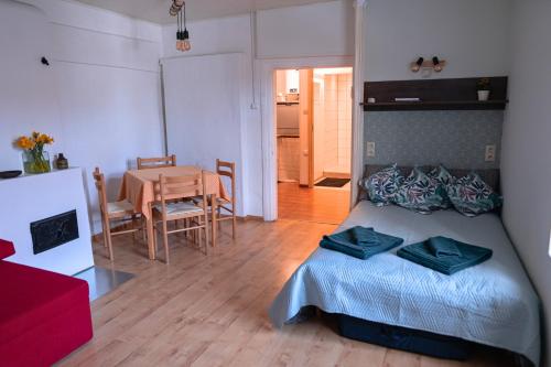 a bedroom with a bed and a dining room with a table at Kantreküla Apartment in Viljandi