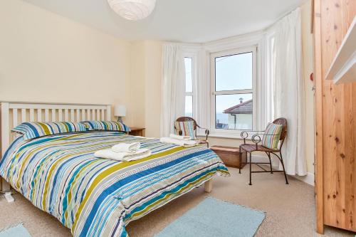 a bedroom with a bed and a desk and a window at The Salt Pot in Ventnor