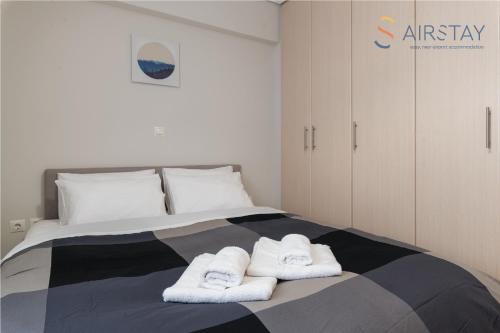 a bedroom with a bed with towels on it at Elise Apartment Airport by Airstay in Spata