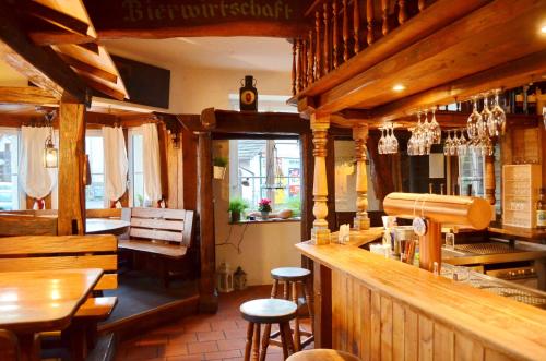 a restaurant with a bar and some stools at Hotel "Cafe Verkehrt" - Wellcome Motorbiker, Berufsleute und Reisende im Schwarzwald in Oberhof