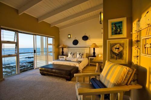 a bedroom with a bed and a view of the ocean at Atlantic Waterfront Cottage D3, 3 bedroom sea view in Swakopmund