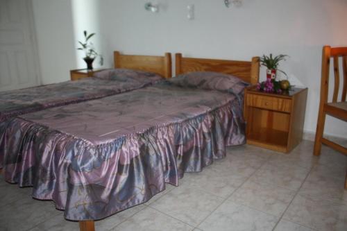 a bedroom with a large bed and a wooden table at Mavromatis Studios in Naxos Chora