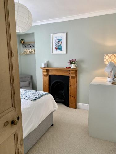 a bedroom with a bed and a fireplace at Spacious, seaside, Victorian home "Bay View Terrace", Penzance in Penzance