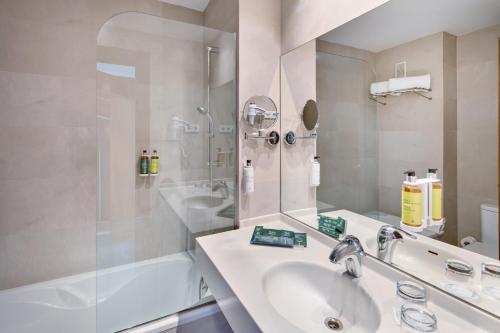 a bathroom with a sink and a shower at Sercotel Kalma Sitges in Sitges