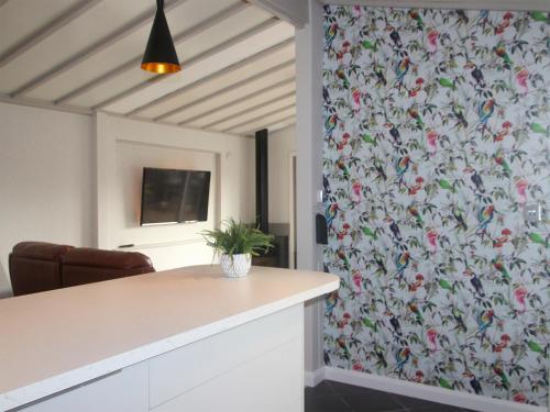 a kitchen with a floral patterned wall with a counter at Sandy Creek Cottage - E5349a in Anderby