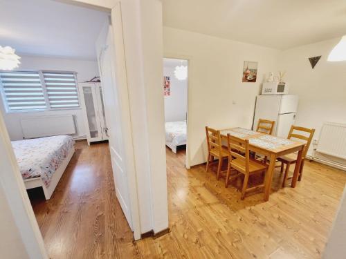 a room with a dining room table and a bedroom at DREAM Apartment in Sinaia
