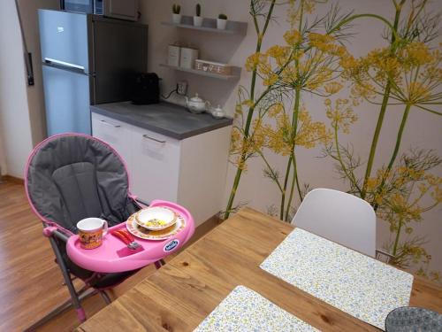 a table with a pink stroller with a cup of coffee on it at Ossola Bella la tua casa in Domodossola