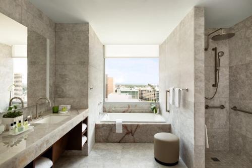 a bathroom with a tub and a sink and a shower at InterContinental Houston, an IHG Hotel in Houston