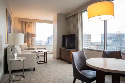 a living room with a couch and a table at InterContinental Houston by IHG in Houston