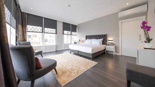 a bedroom with a bed and a couch and a chair at Loop Hotel Bosphorus İstanbul in Istanbul