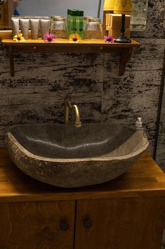 a stone sink with a faucet on a counter at Stefanis Guest House in Krásion