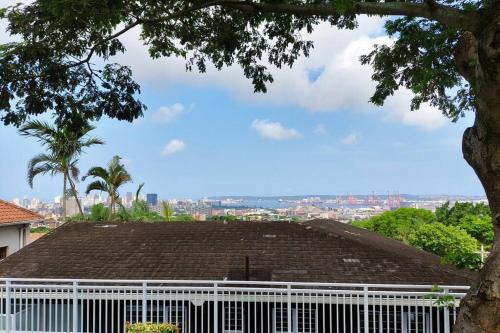 a white fence in front of a house at Harbour View House in Durban