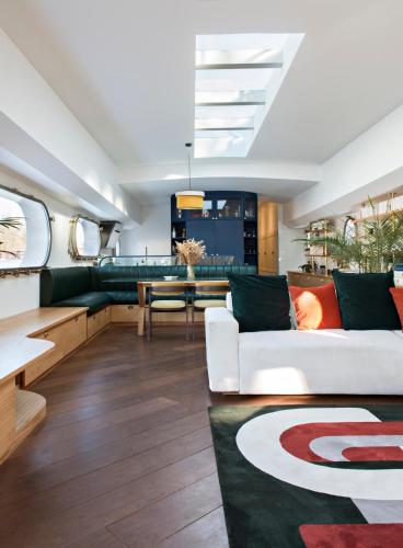 a living room with a white couch and a table at Escale Sur Seine in Paris