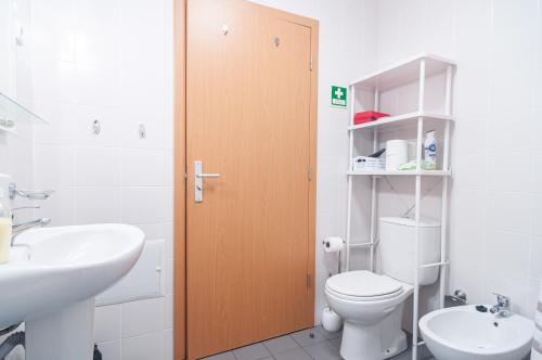 a bathroom with a toilet and a sink at Island Jewel in Vila Franca do Campo