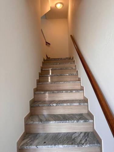 a staircase with wooden steps and a light on the ceiling at Casetta sul Mare in Fano