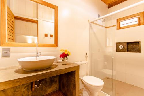 a bathroom with a sink and a toilet and a shower at CASA na PRAIA DA BARRINHA Frente Mar in Barrinha