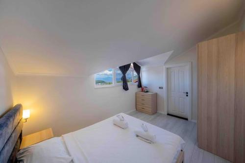 a bedroom with a white bed and a window at Comfort-design-peace of mind in Fethiye