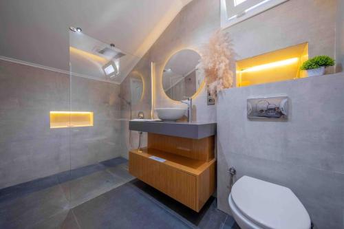 a bathroom with a sink and a toilet and a mirror at Comfort-design-peace of mind in Fethiye