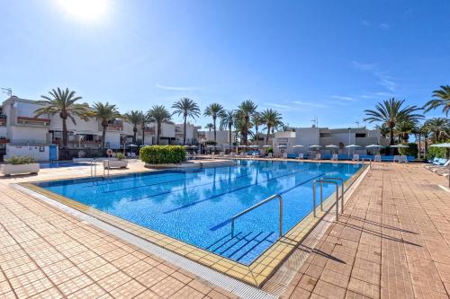 una gran piscina con palmeras en un complejo en Stunning lovely flat with Pool and strong Wi-Fi, en Arona