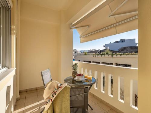 a balcony with a table and a view of a building at Marita Luxury Apartment with parking space in Chania