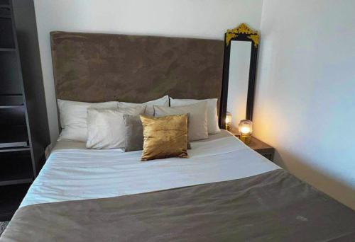 a bedroom with a large bed with two pillows at Private Room in Apartment in Malmö