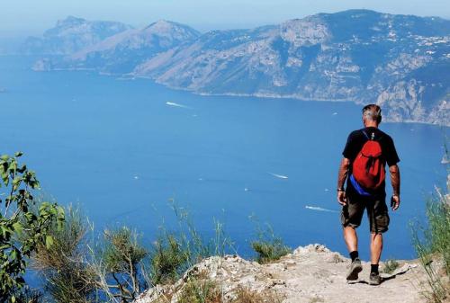 a man with a backpack standing on top of a mountain at Mon Reve 2 in Pianillo
